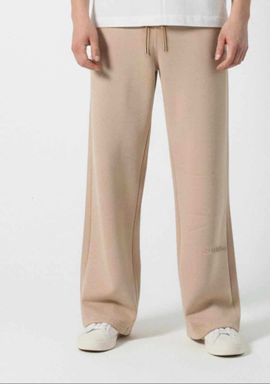 Full look of a model wearing the Herman men's beige wide-leg joggers.