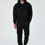 Model wearing the Herman men's black oversized zip hoodie with matching joggers