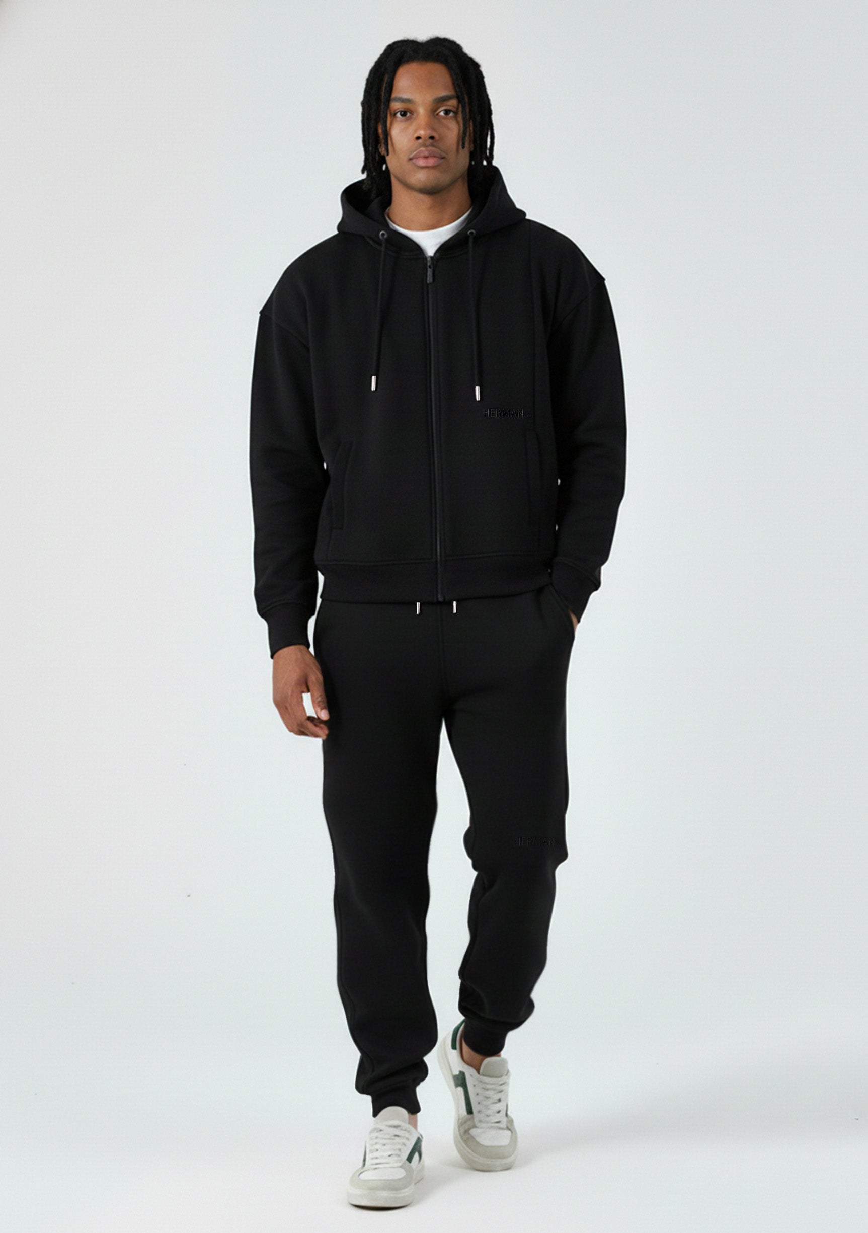 Model wearing the Herman men's black oversized zip hoodie with matching joggers