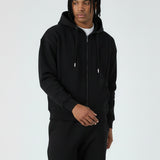 Model walking in the Herman men's black oversized zip hoodie, showing the relaxed fit