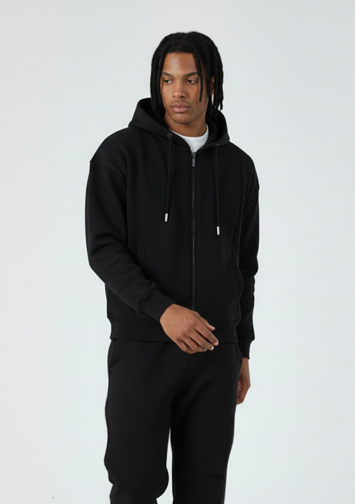 Model walking in the Herman men's black oversized zip hoodie, showing the relaxed fit
