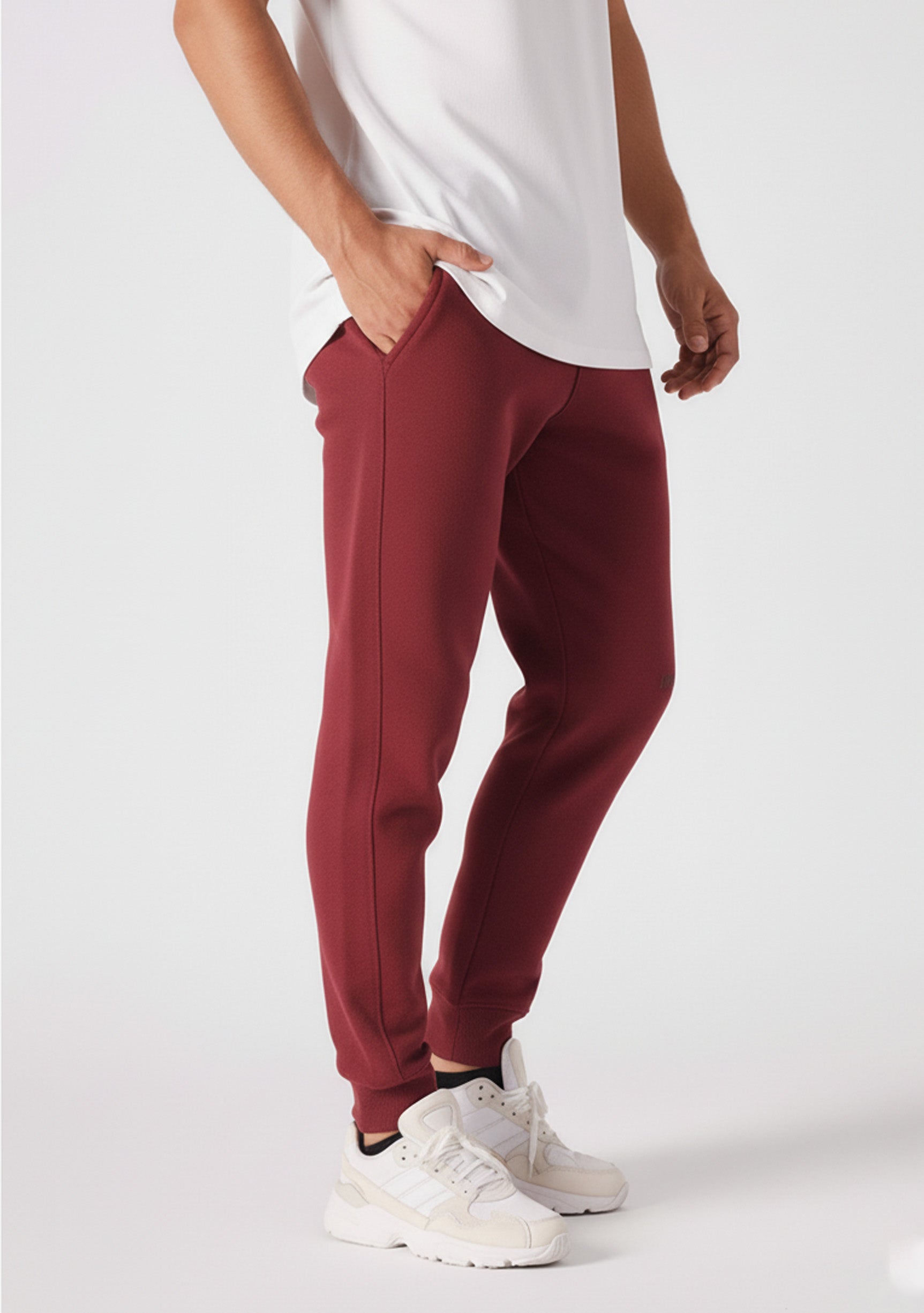Side profile of a model wearing the Herman men's burgundy tapered joggers.