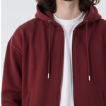 Close up detail of the Herman men's burgundy zip hoodie, showing the fabric and zip.