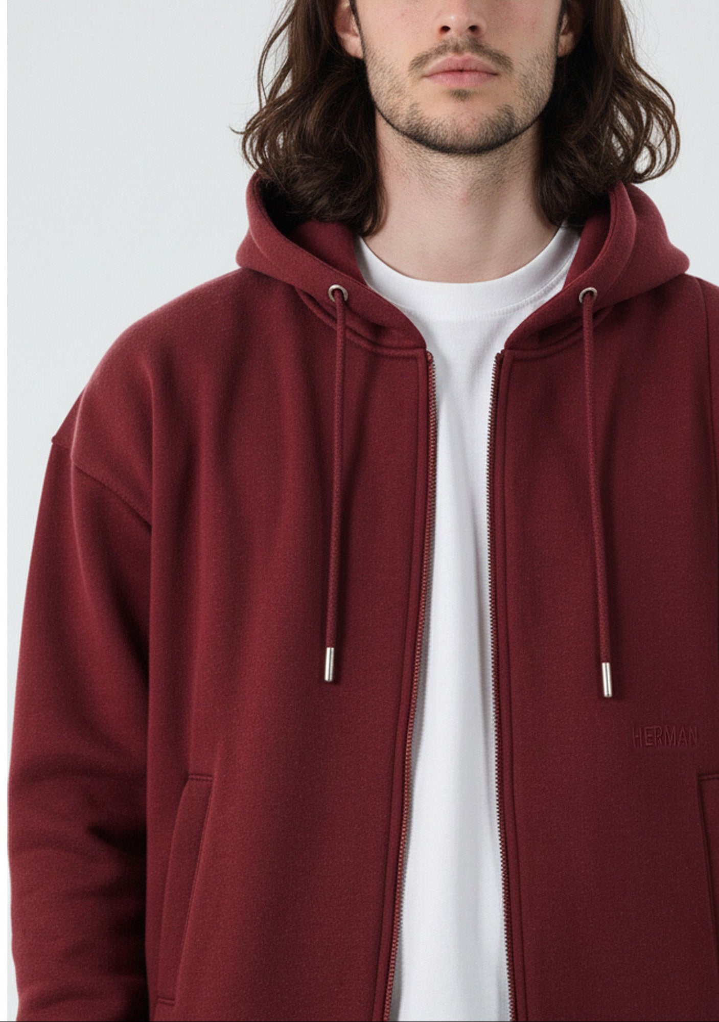 Close up detail of the Herman men's burgundy zip hoodie, showing the fabric and zip.
