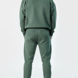 Back view of the Herman men's green tracksuit, showing the oversized fit of the hoodie.