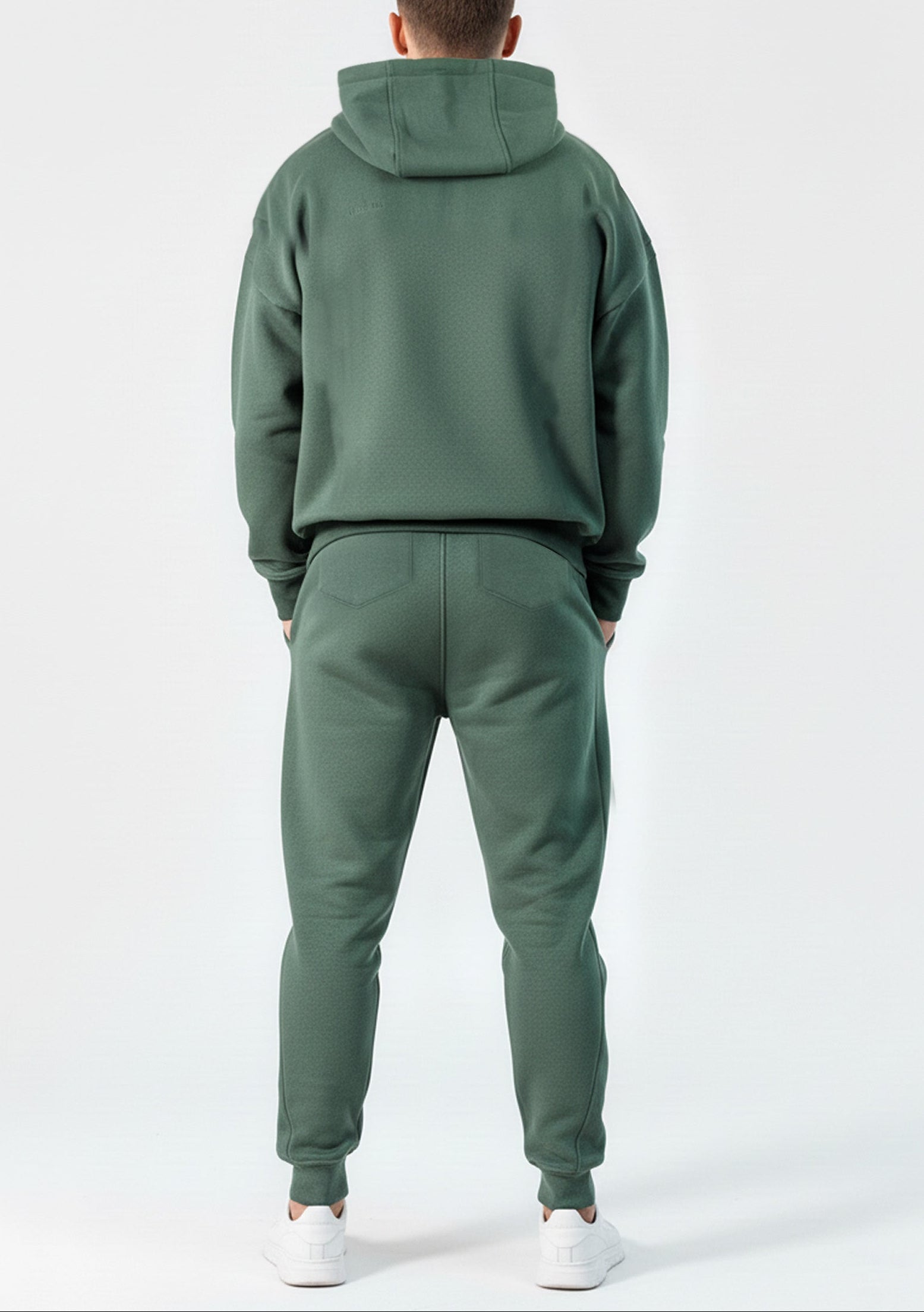 Back view of the Herman men's green tracksuit, showing the oversized fit of the hoodie.