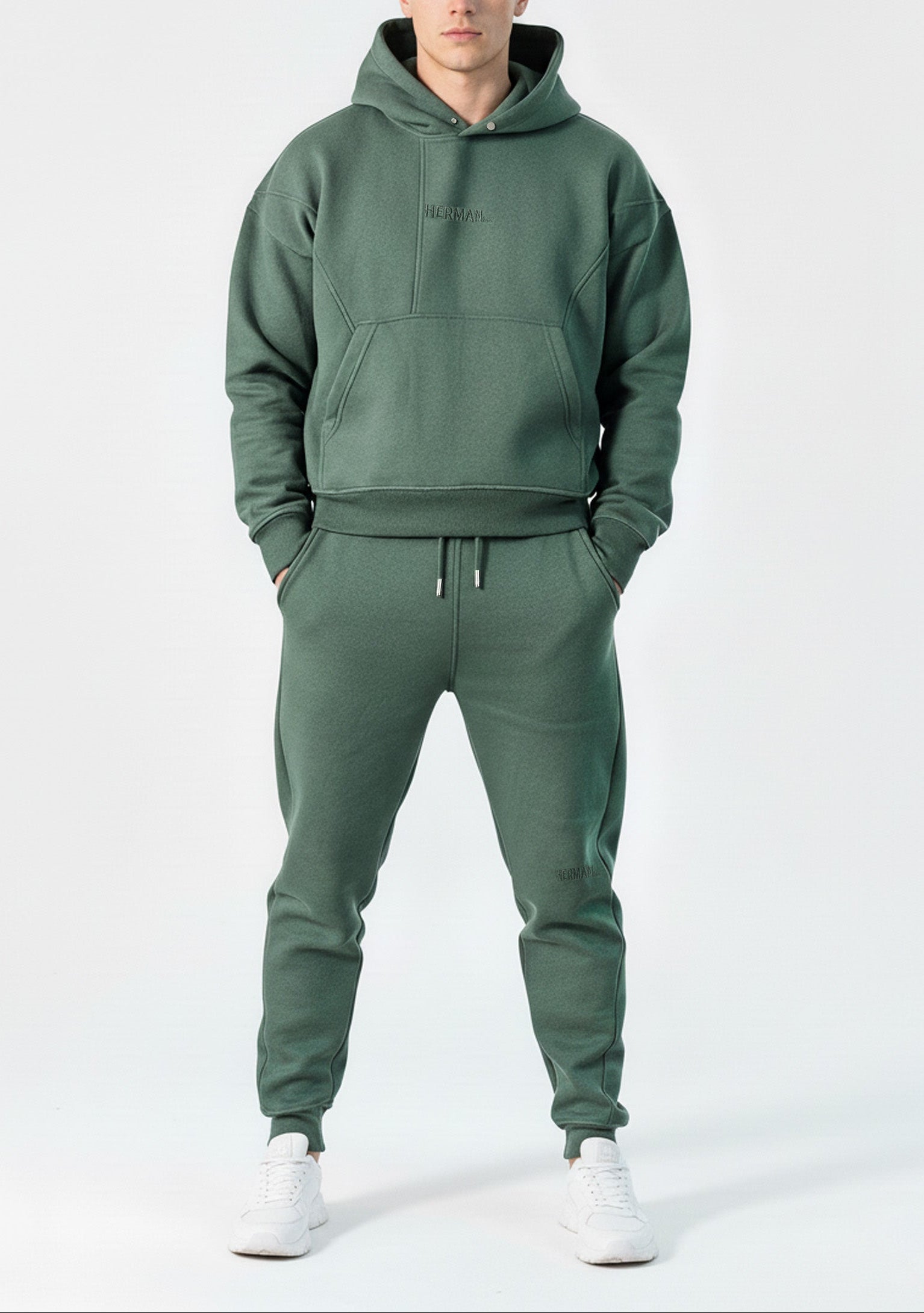 Full front view of a model wearing the Herman men's green popper neck hoodie and matching joggers.