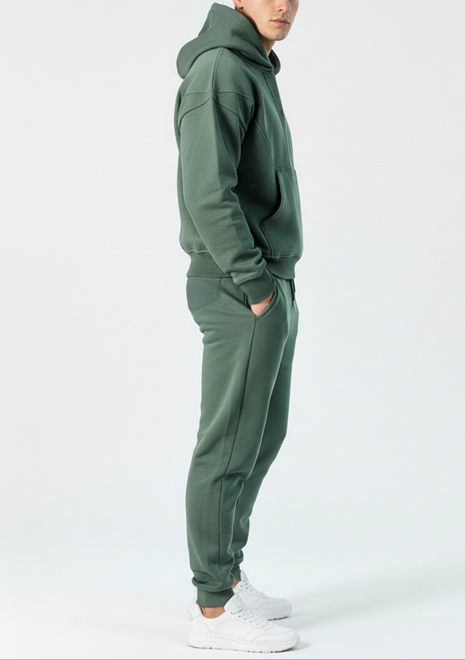 Side profile of the Herman men's green popper neck hoodie and joggers.
