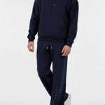 Angled front view of a model wearing the Herman men's navy popper neck hoodie and joggers set.