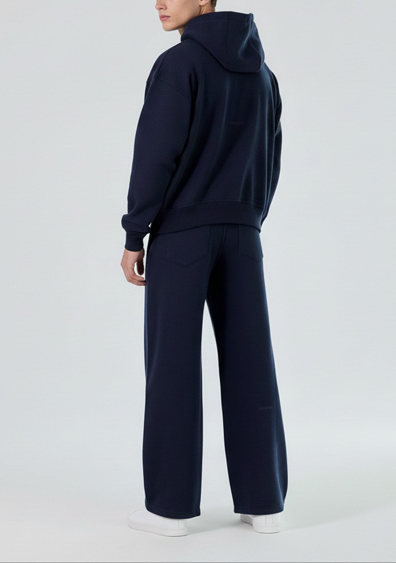 Back view of the Herman men's navy tracksuit, showing the oversized fit of the hoodie.
