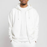 Model wearing the Herman men's white oversized zip hoodie with matching joggers