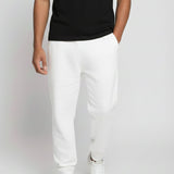 Angled front view of the Herman men's white tapered joggers highlighting the soft jersey fabric