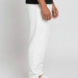 Full side profile of a model wearing the Herman men's white tapered joggers