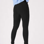 An angled back view of the black jeggings highlighting the supportive stretch fabric.