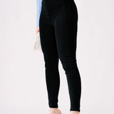 Profile shot of the black high rise jeggings showing the sculpted silhouette.