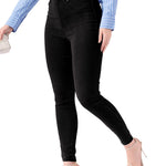 A woman walking to show the flexibility and comfort of the high rise black jeggings for women.