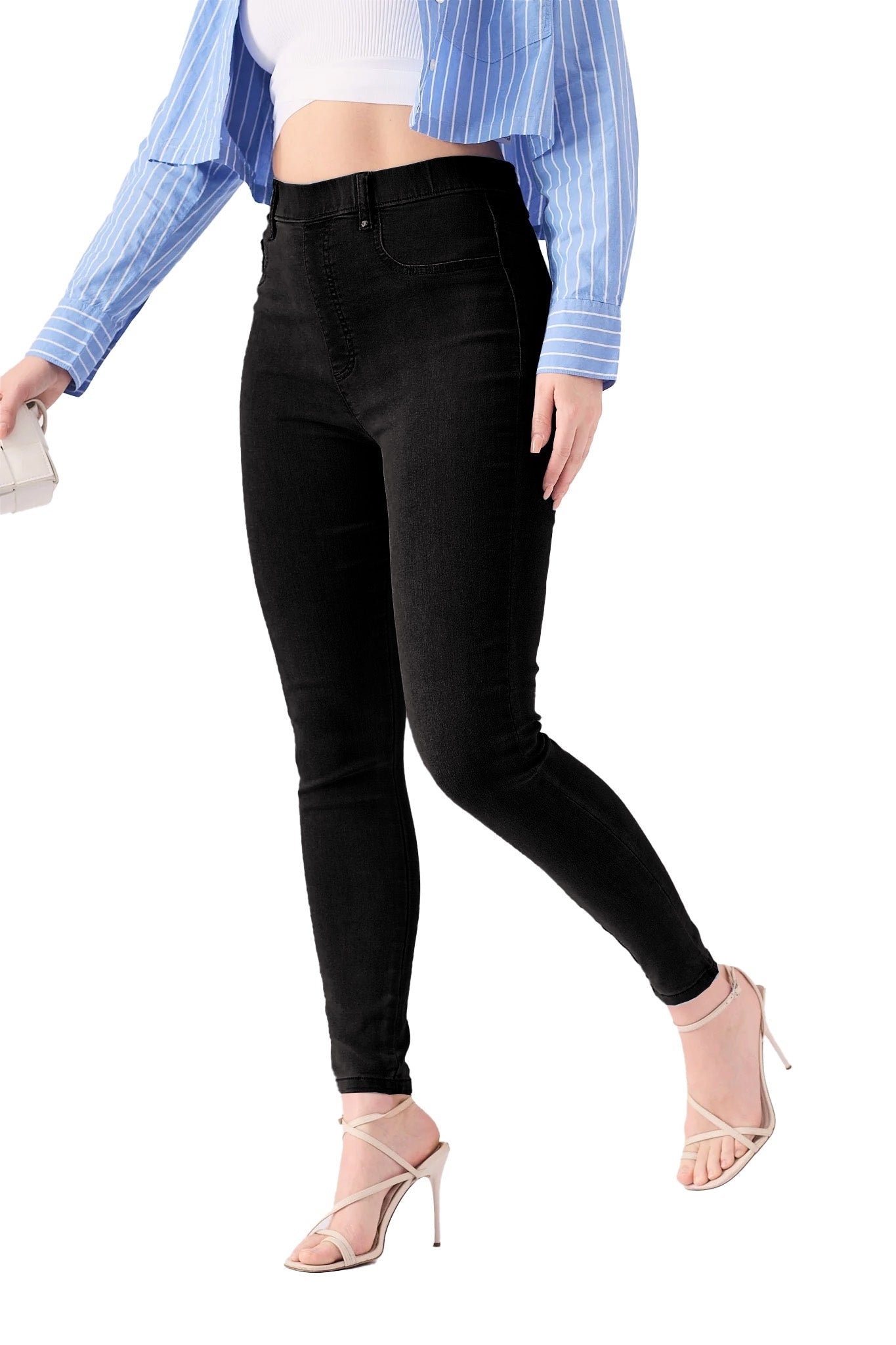 A woman walking to show the flexibility and comfort of the high rise black jeggings for women.