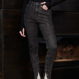 Showcasing the fit of the high-waisted black acid wash skinny jeans