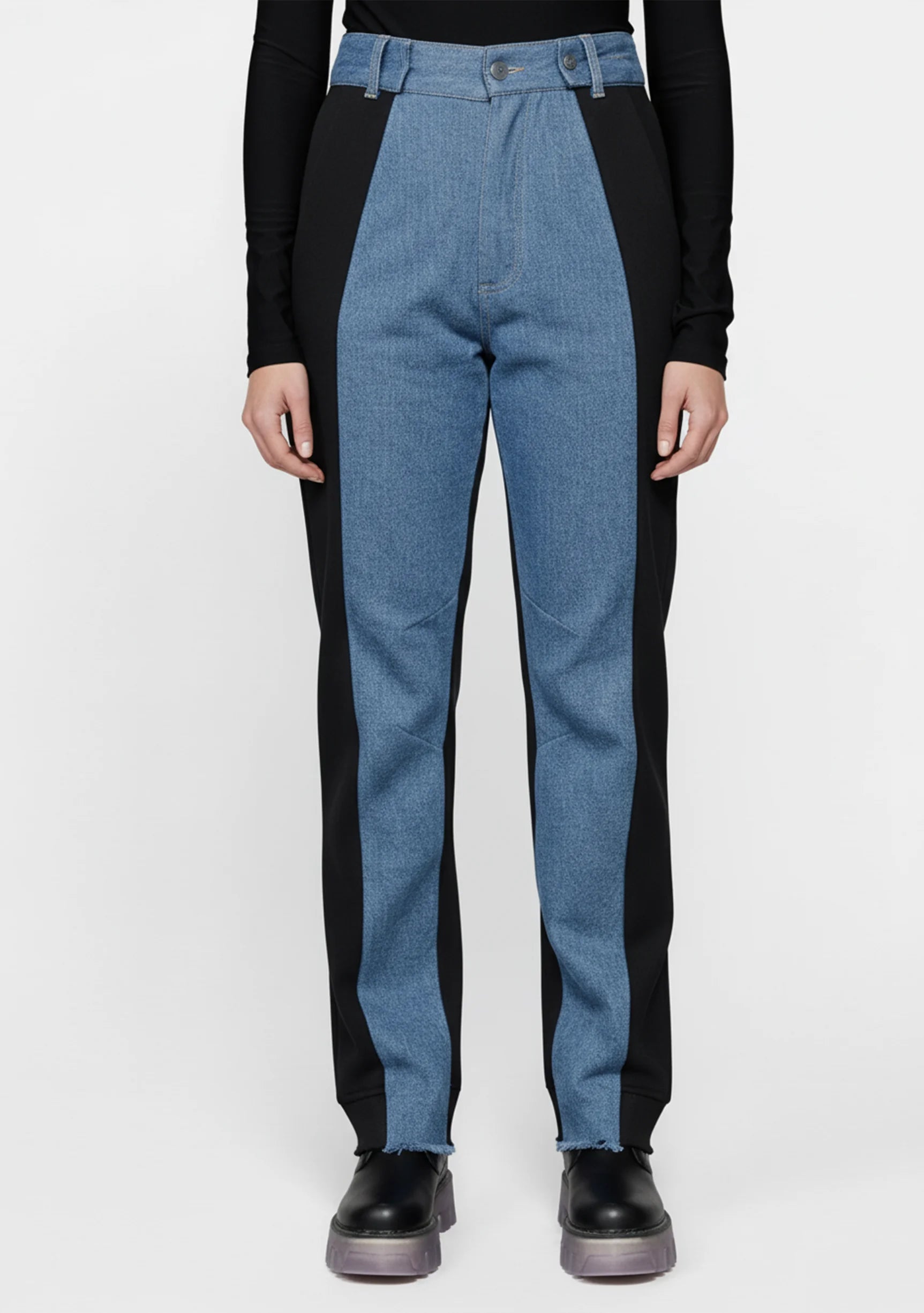 Full front view of a model wearing high-waisted two-tone straight jeans with black side panels.