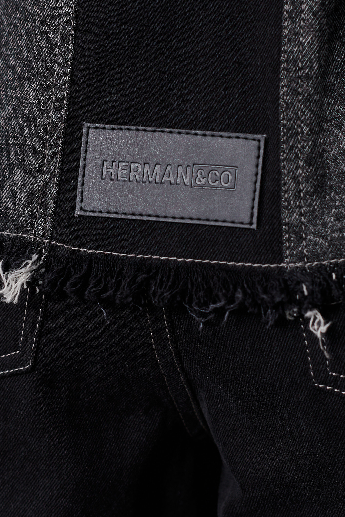 Jmojo black contrast denim jacket Herman and Co vegan leather patch close up