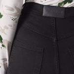 Jmojo black skinny jeans back waist close up vegan leather badge