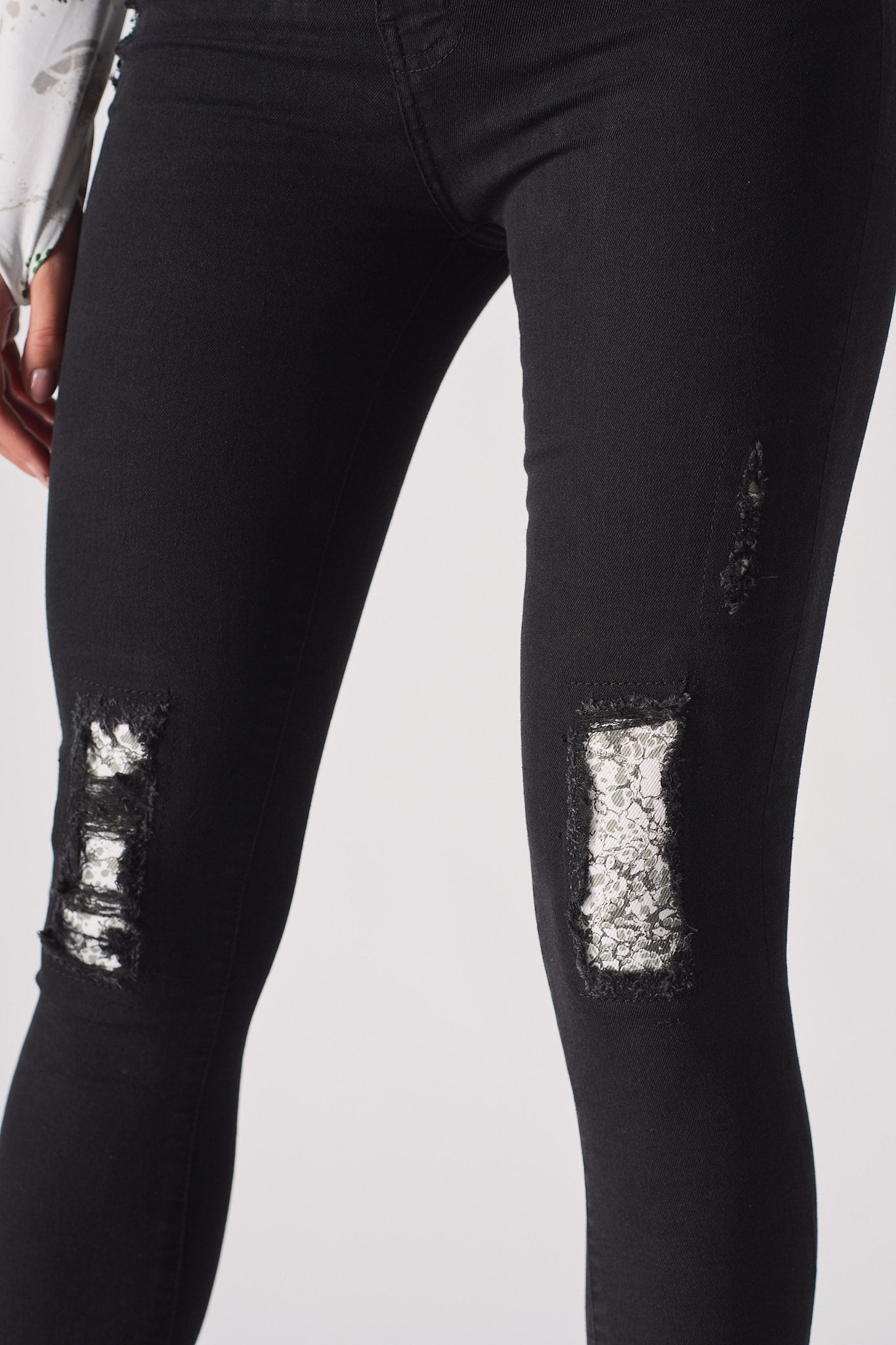 Jmojo black ripped skinny jeans close up lace under print knee panels