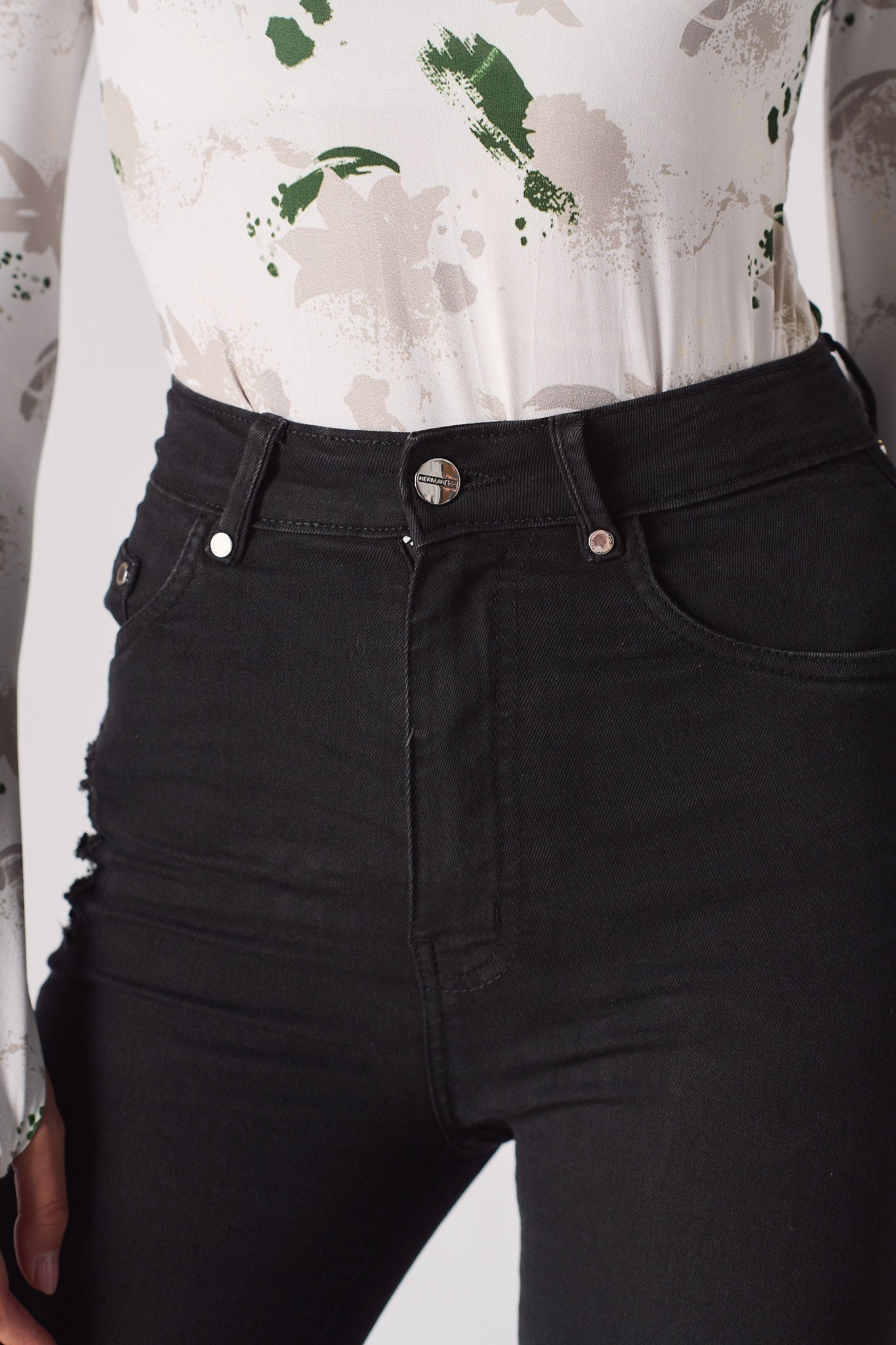 Jmojo black skinny jeans close up waist button and hardware detail