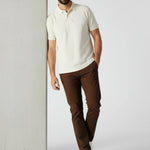 Model leaning against wall wearing JMOJO men's dark brown slim fit chinos