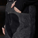 Close up of silver branded button hardware and heart cut out panel detail on Jmojo black wash jeans