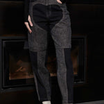 Close up front view of Jmojo black acid wash heart panel tapered jeans on model