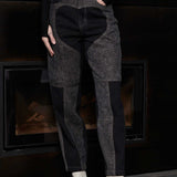 Close up front view of Jmojo black acid wash heart panel tapered jeans on model
