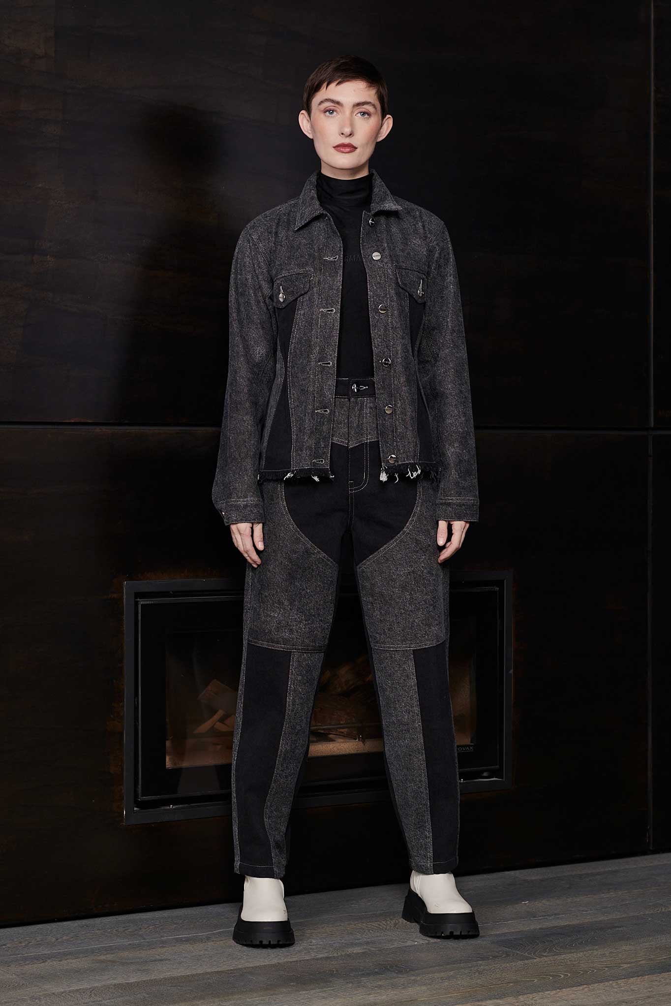 Model wearing Jmojo black acid wash heart panel tapered jeans with matching denim jacket full length