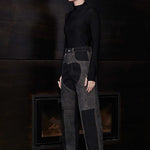 Side view of model wearing Jmojo black and acid wash tapered fit heart panel jeans