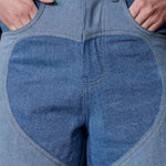 Close up of silver button hardware and heart cut out panel detail on Jmojo blue wash jeans