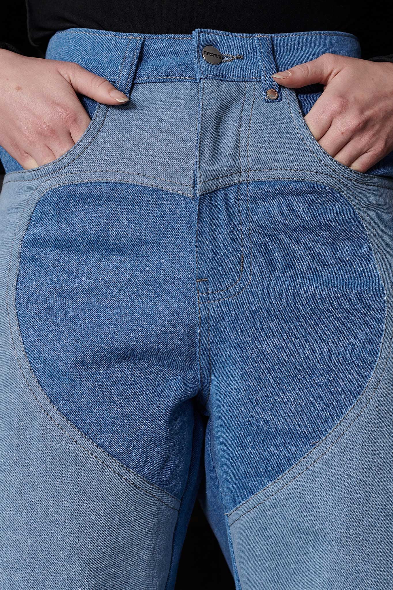 Close up of silver button hardware and heart cut out panel detail on Jmojo blue wash jeans