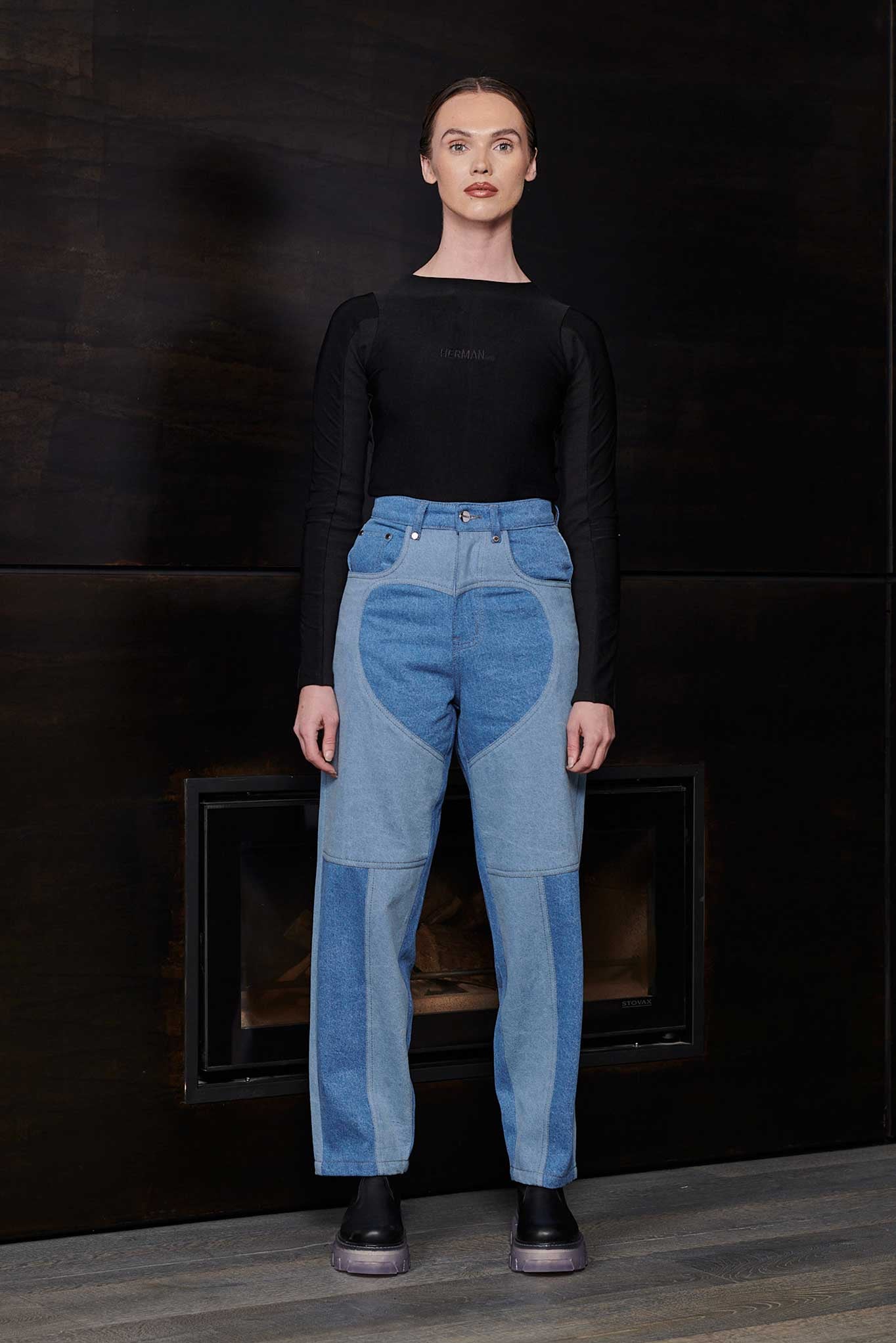 Model wearing Jmojo heart panel tapered fit jeans in contrasting blue wash full length view