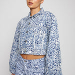 Jmojo marble print cropped denim jacket angled front view on model