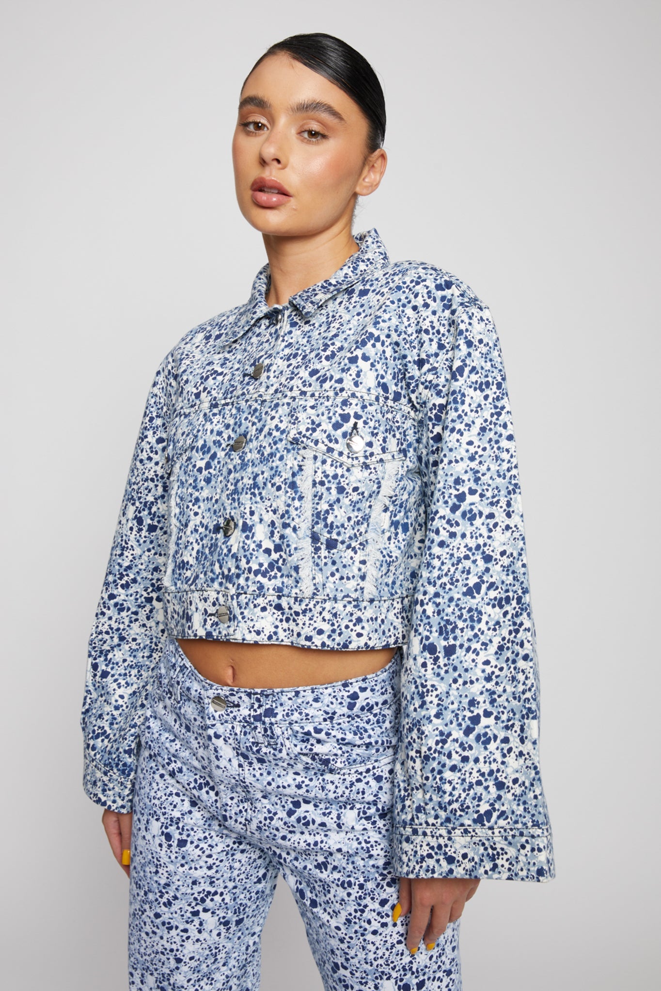 Jmojo marble print cropped denim jacket angled front view on model