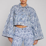 Jmojo marble print cropped denim jacket front close up showing wide flared sleeves