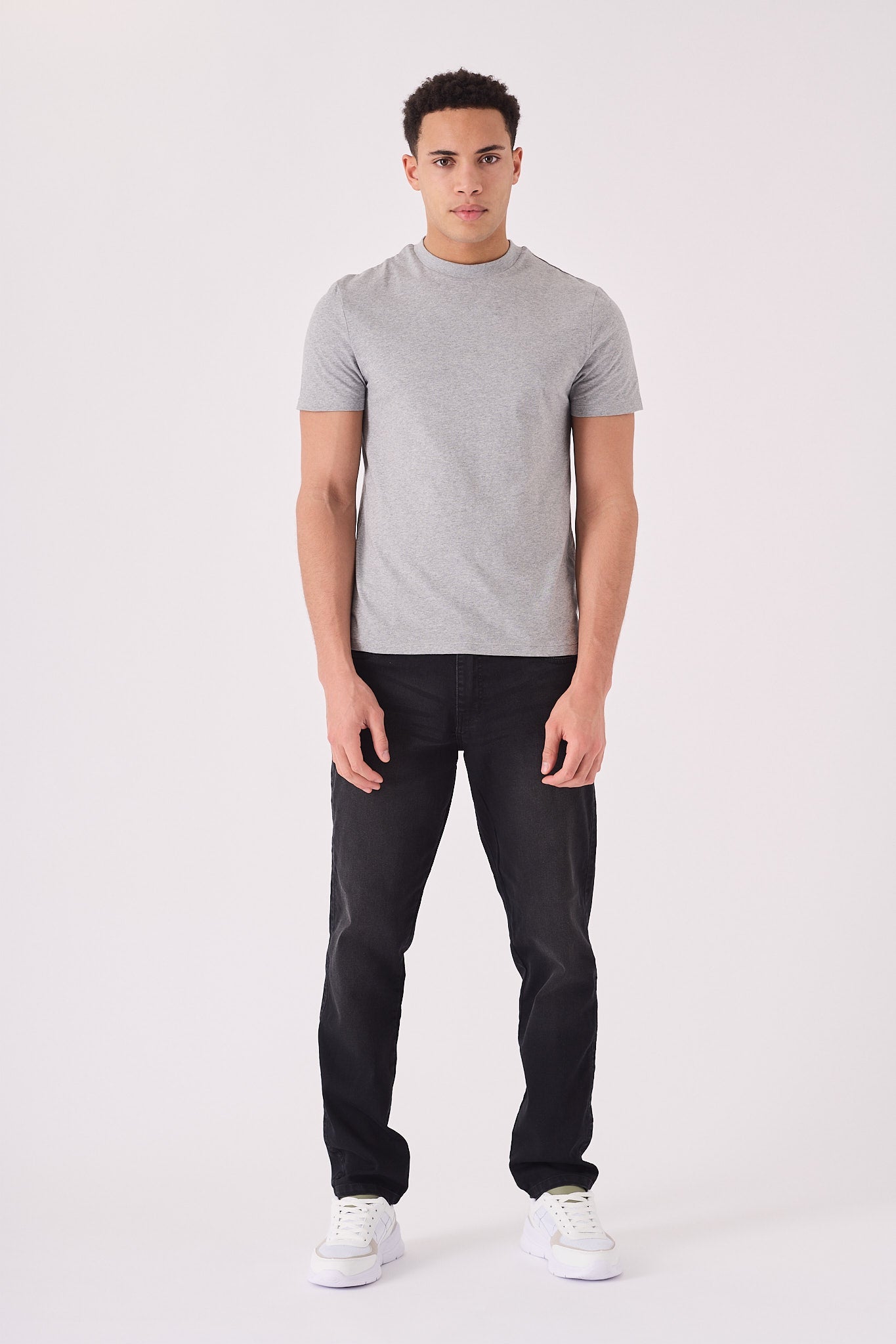 Men's straight fit black jeans side view showing straight leg silhouette from hip to ankle