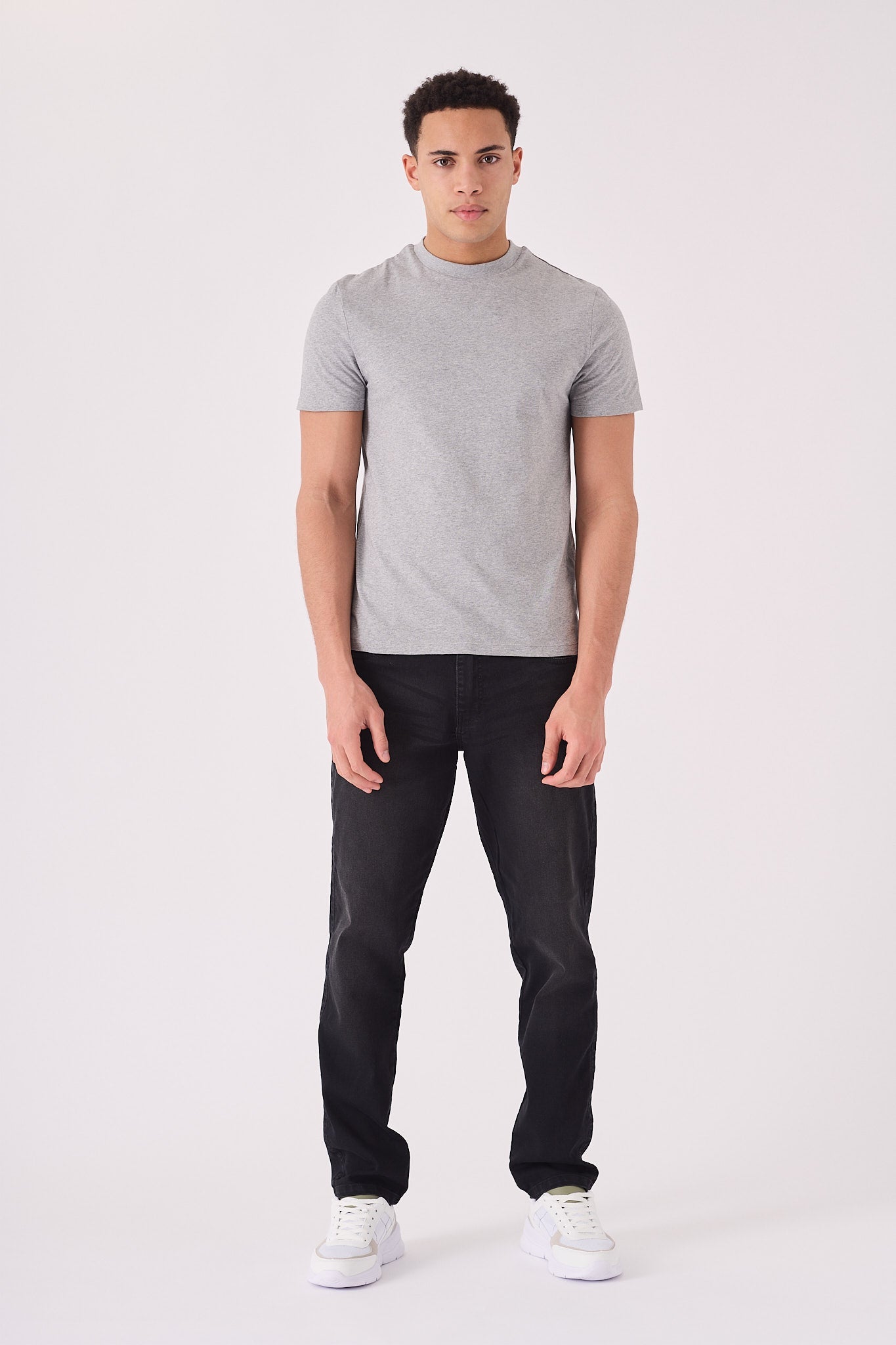 Men's straight fit black jeans side view showing straight leg silhouette from hip to ankle