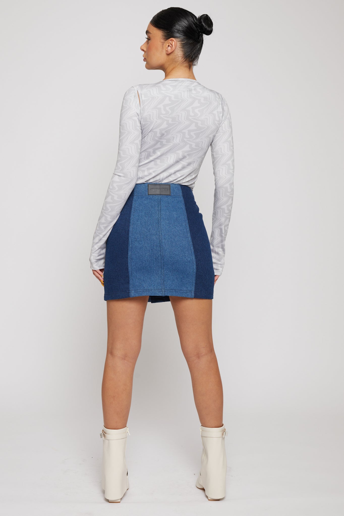 Jmojo high waist patchwork denim mini skirt back view on model with white boots