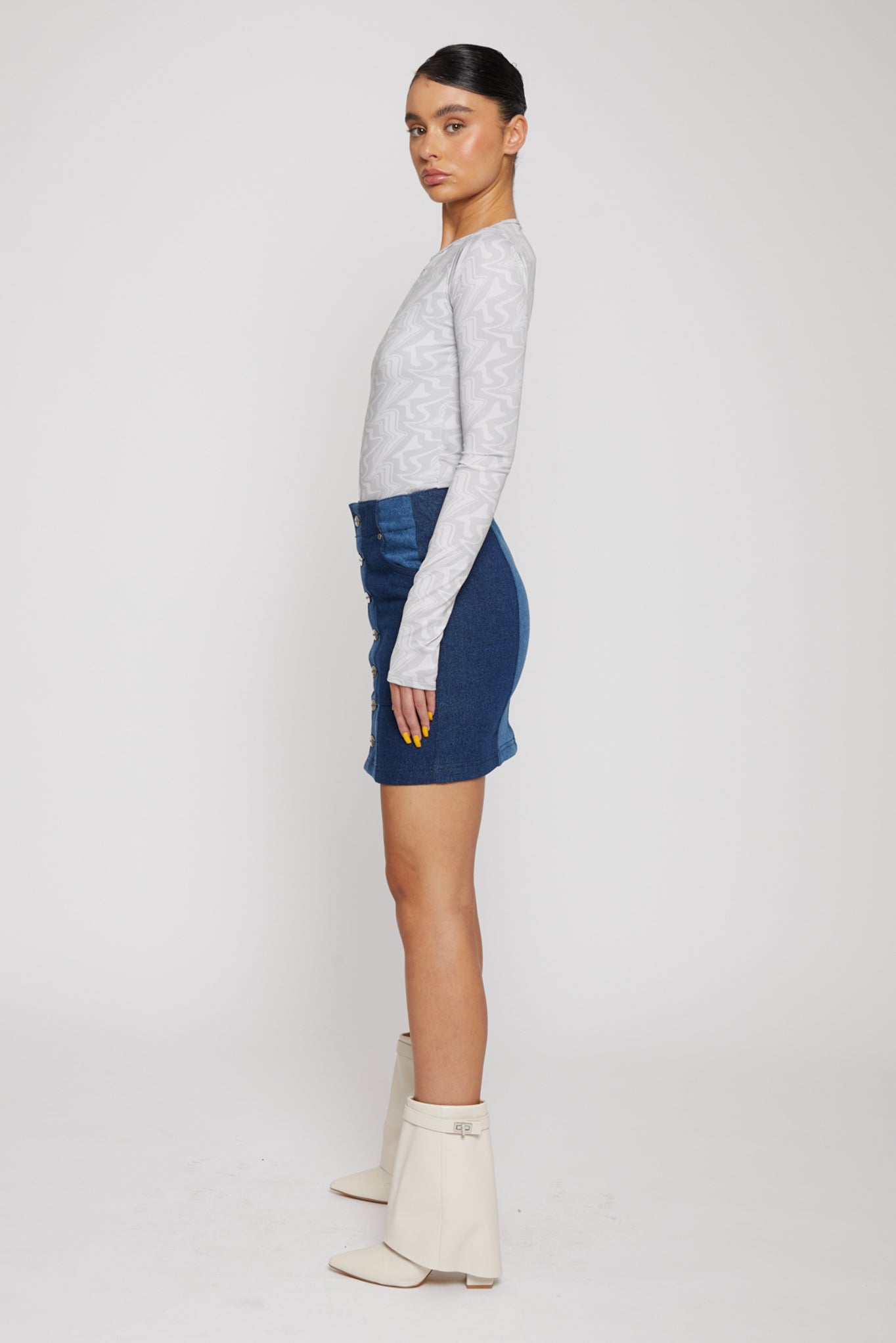 Jmojo patchwork denim mini skirt side view on model showing snap buttons