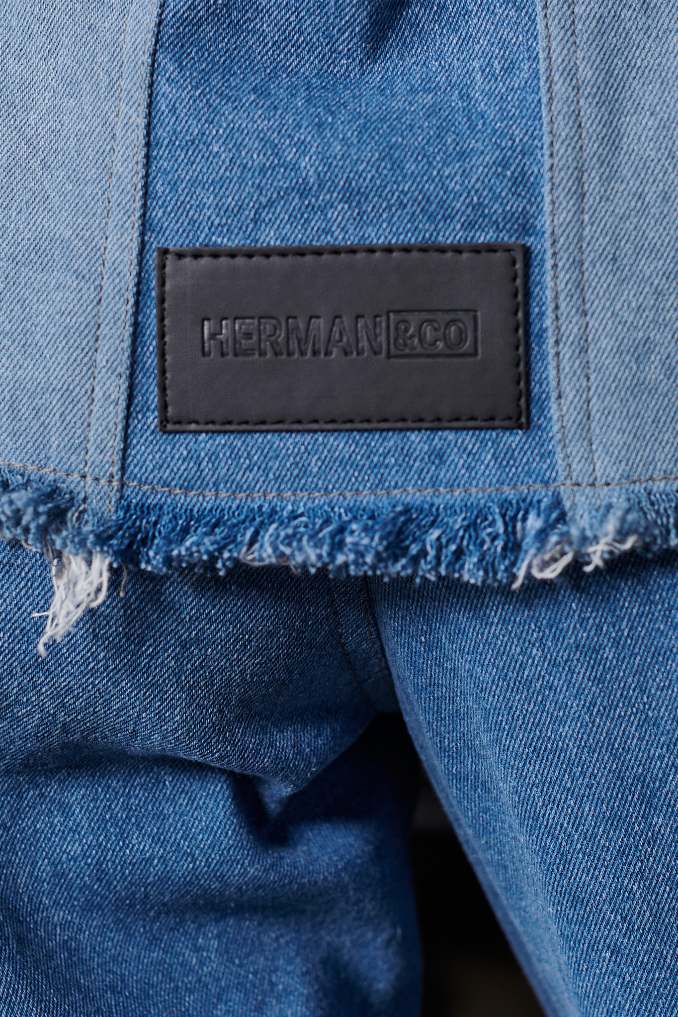 Jmojo two tone denim jacket Herman and Co vegan leather patch close up