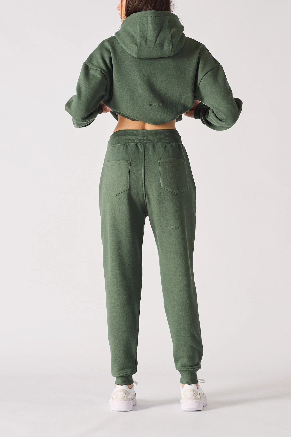 Rear view showing the relaxed fit of these khaki green joggers women.