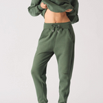 Full body front shot of a model wearing khaki green joggers women and matching hoodie.