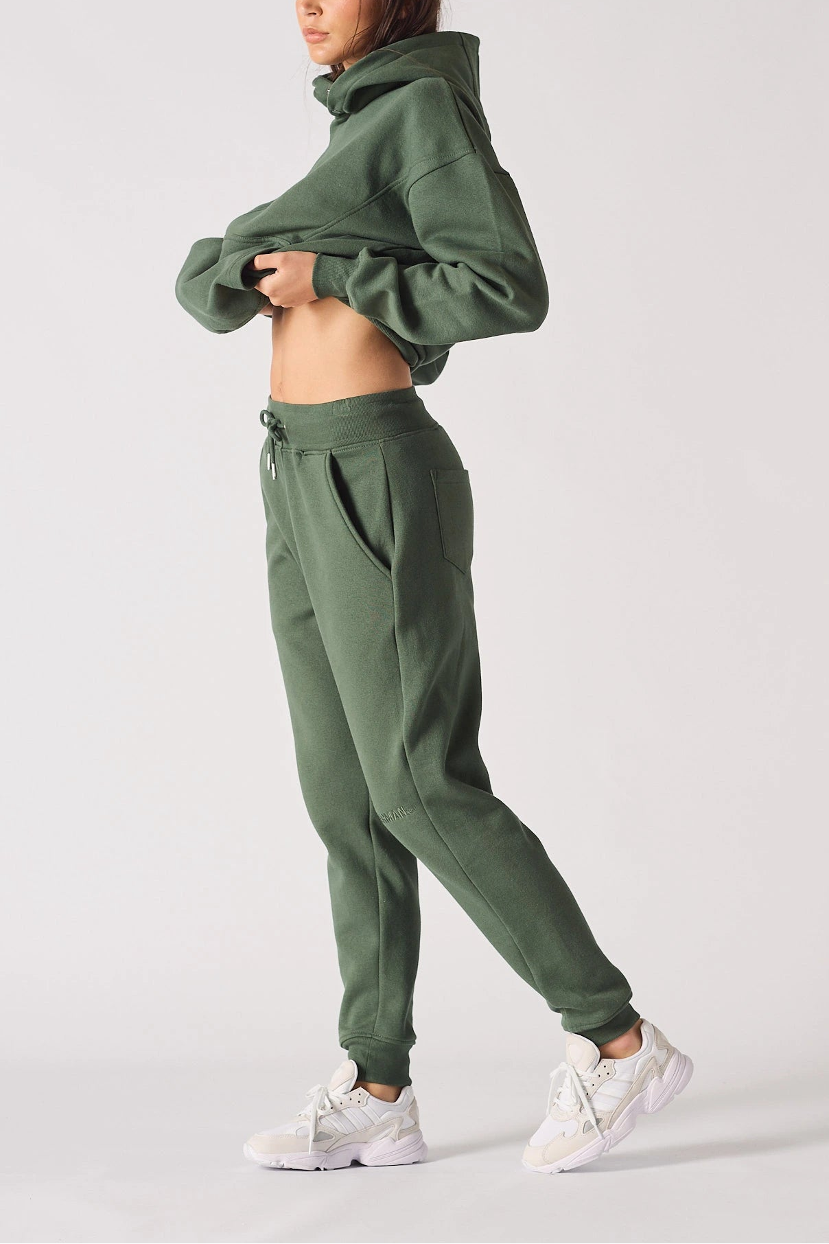 Side view of a model posing in comfortable khaki green joggers women.