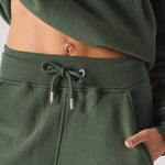 Close up of the adjustable drawstring waist on khaki green joggers women.