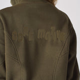 Detailed shot of the tonal embroidered branding on the back of a khaki sweatshirt