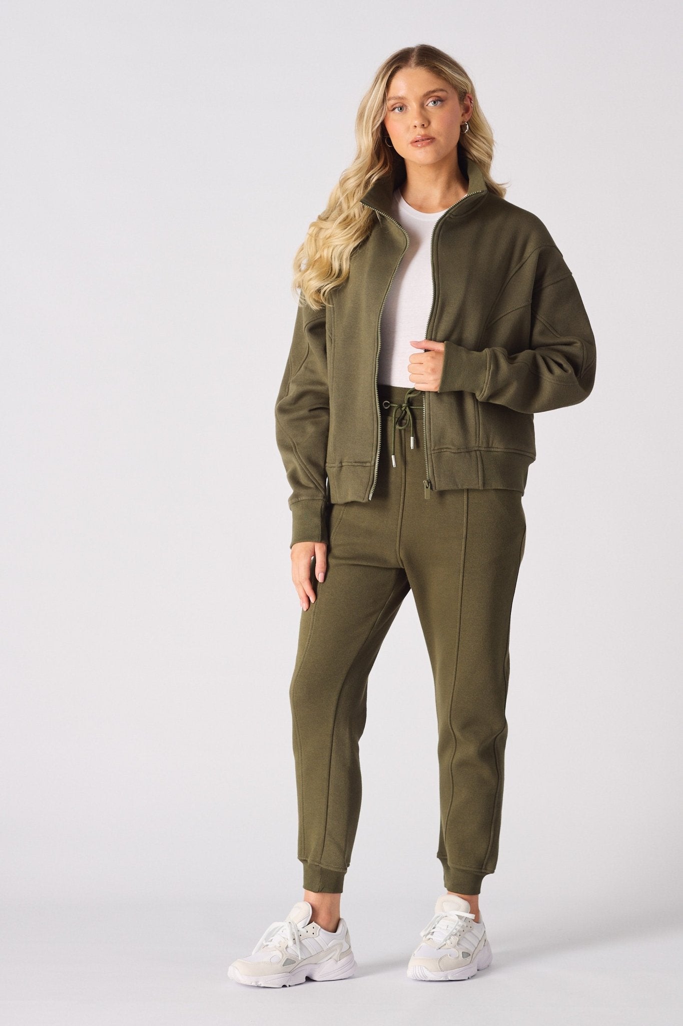 Full front view of a khaki zip up sweatshirt paired with matching cuffed joggers